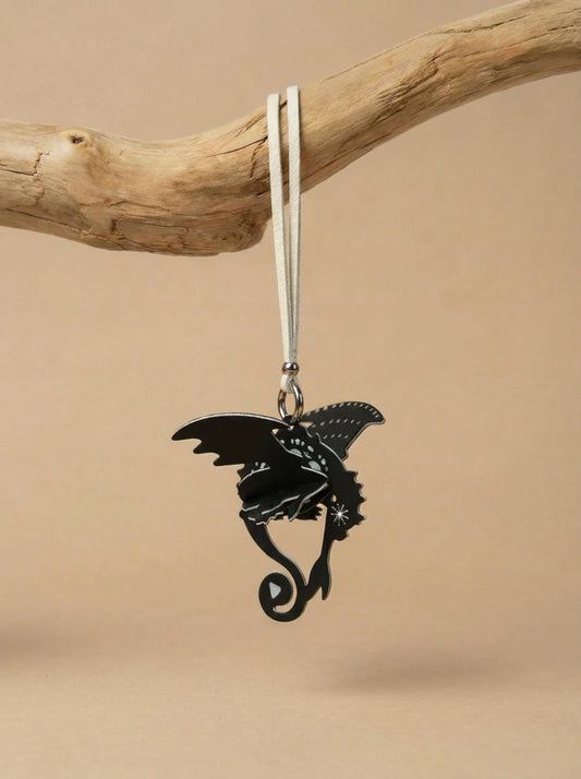 Black dragon air freshener hanging in car