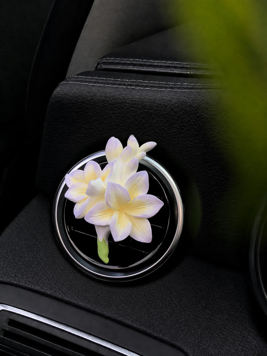 Lavender Cream Freesia ornament mounted naturally on a round car vent