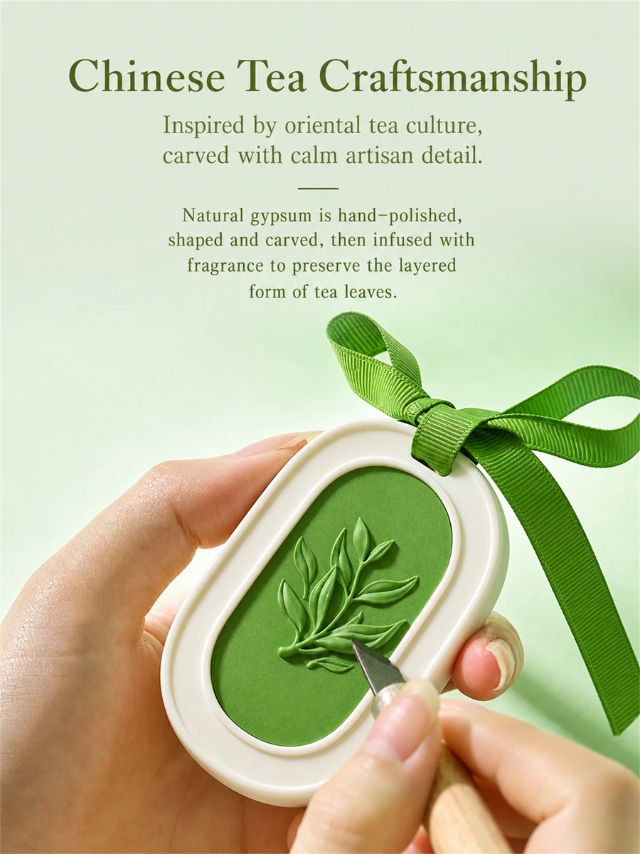 Hand holding tea scented gypsum air freshener with green ribbon