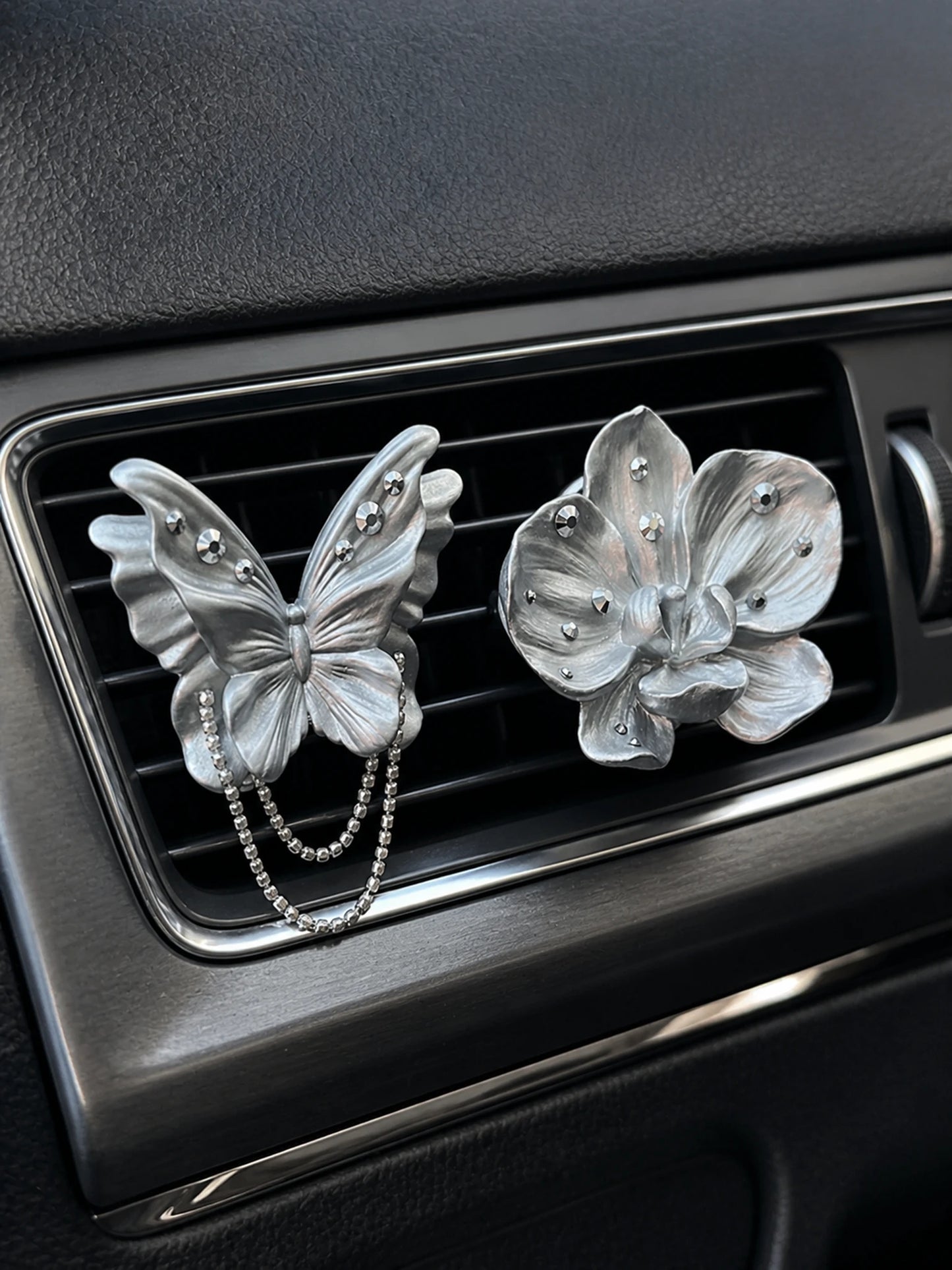 Pearl silver butterfly and orchid ornaments installed as separate car vent accents