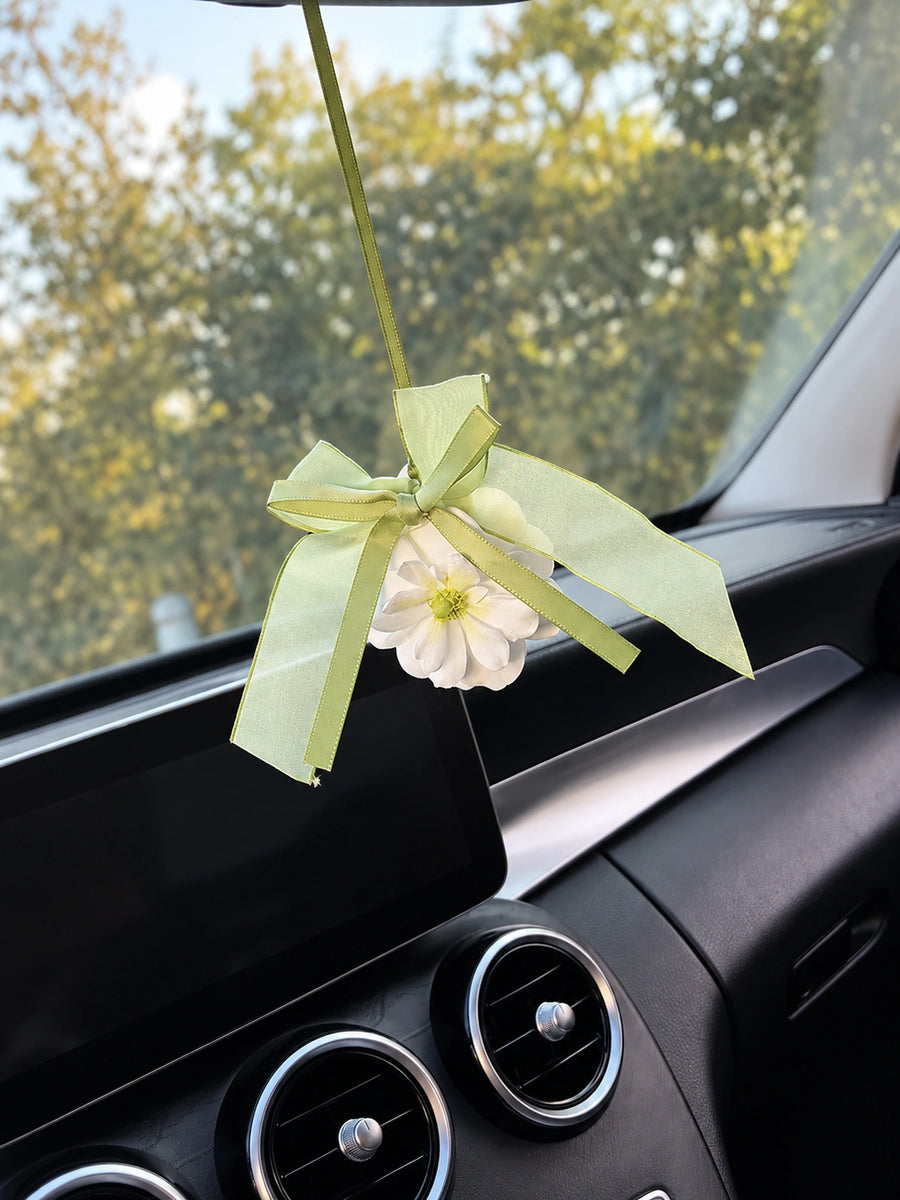 Green Ribbon Flower hanging charm with its wide translucent bow in the original car interior