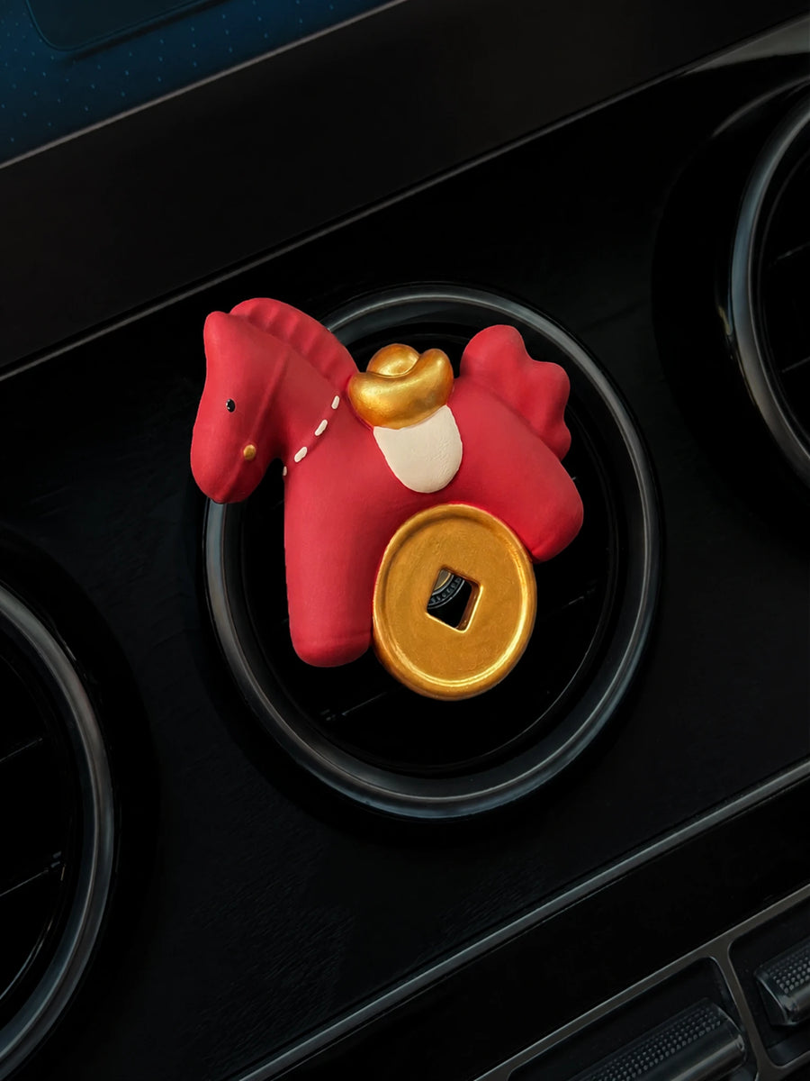 Scarlet Horse with gold ingot and round coin mounted squarely on a circular car vent