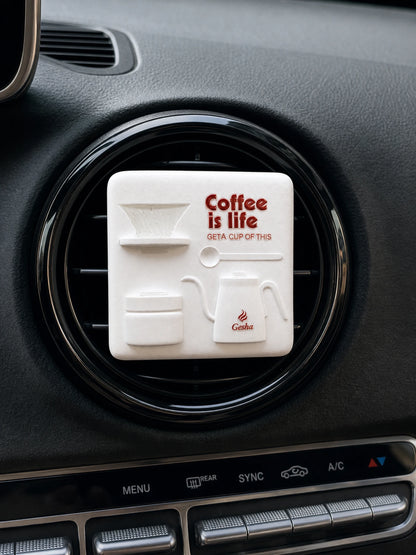 Square Coffee Ritual piece with raised coffee-tool relief and physical lettering