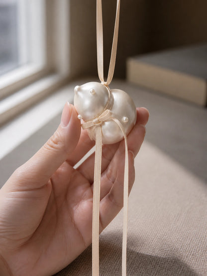 Pearl Gourd Hanging Car Charm shown at hand scale