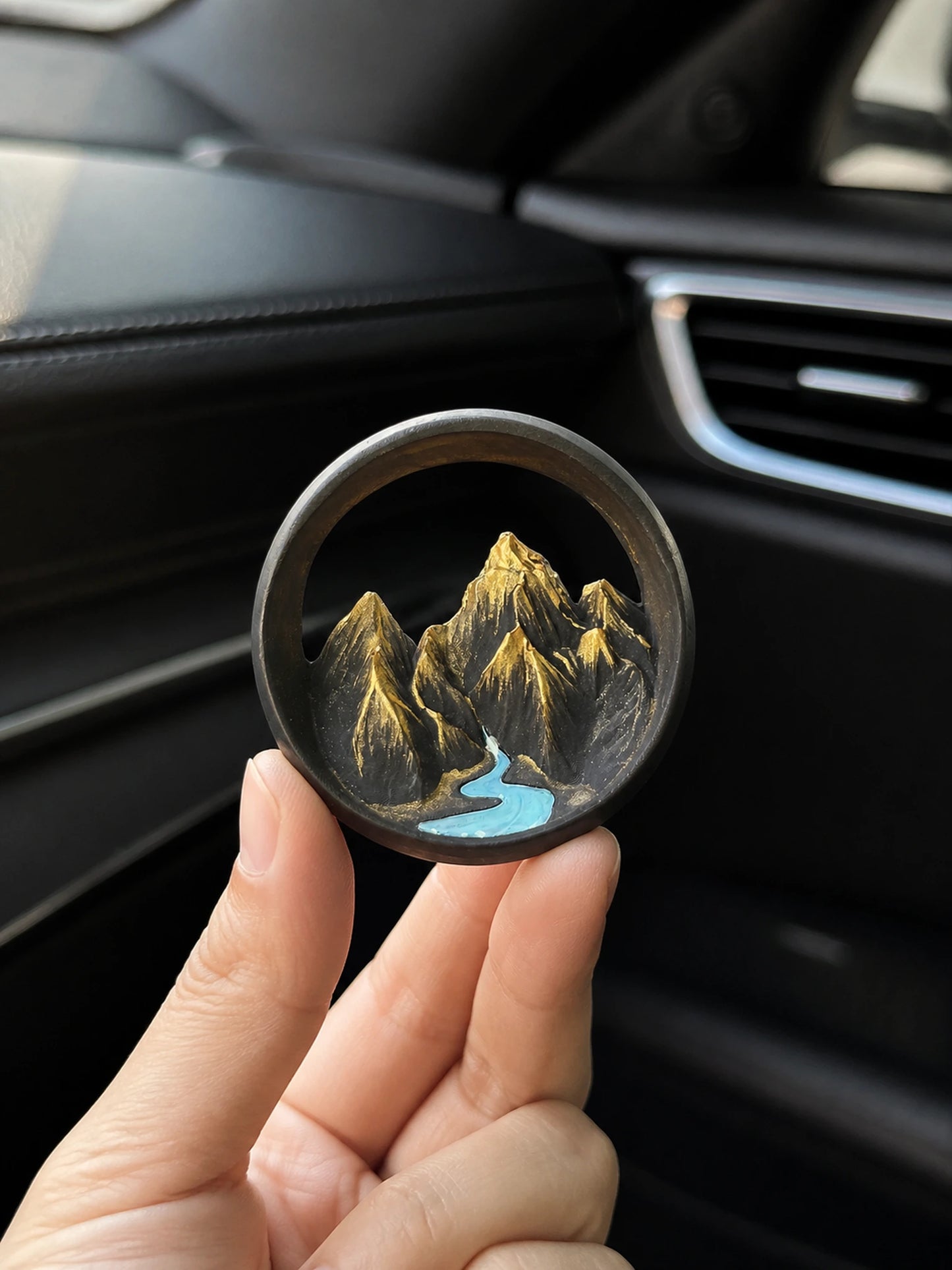 Ink Mountain Stream car vent piece shown at honest hand scale