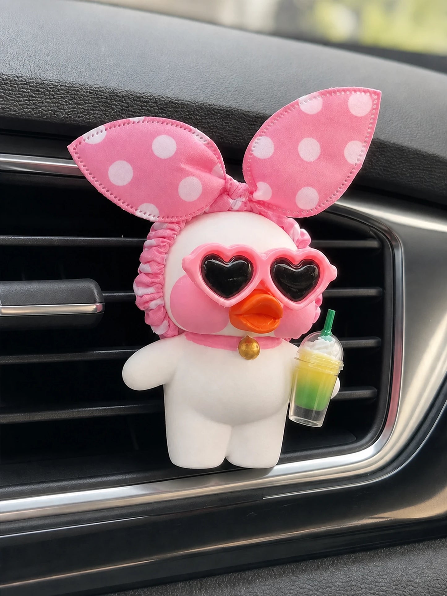 Blush Duck Car Vent Diffuser secured to a car vent