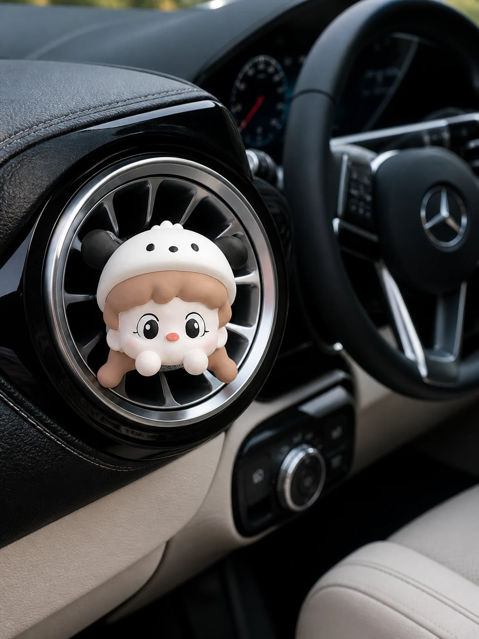 Cream Cap Girl car vent charm installed in a Mercedes-Benz interior
