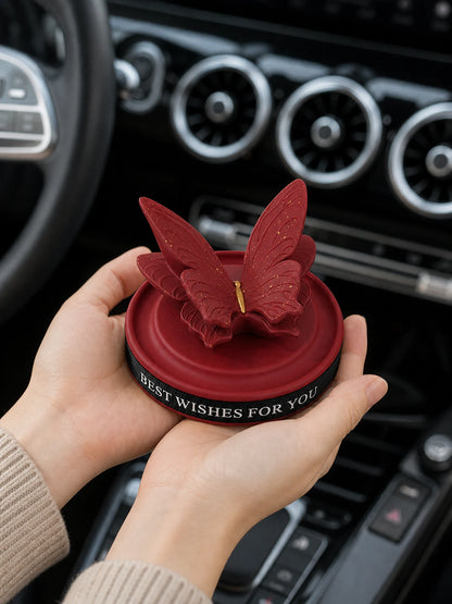 Burgundy Butterfly Dashboard Ornament shown at hand scale