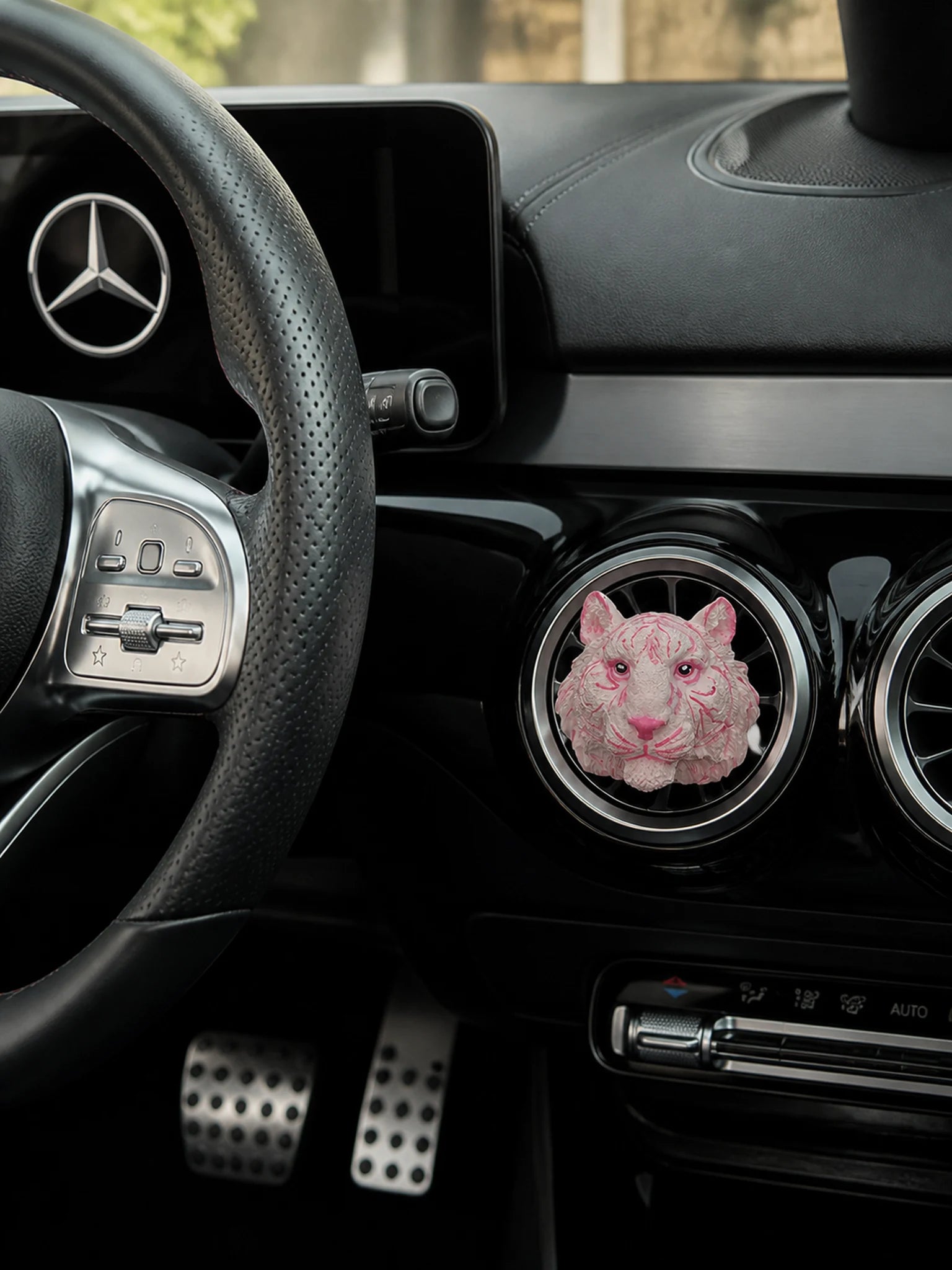 Blush Tiger car vent charm installed in a Mercedes-Benz interior