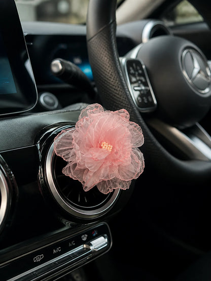 Blush Rose car vent charm installed on a Mercedes-Benz vent