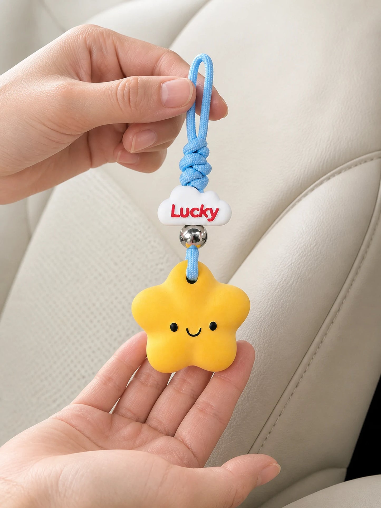 Lucky Star Hanging Car Charm shown at hand scale