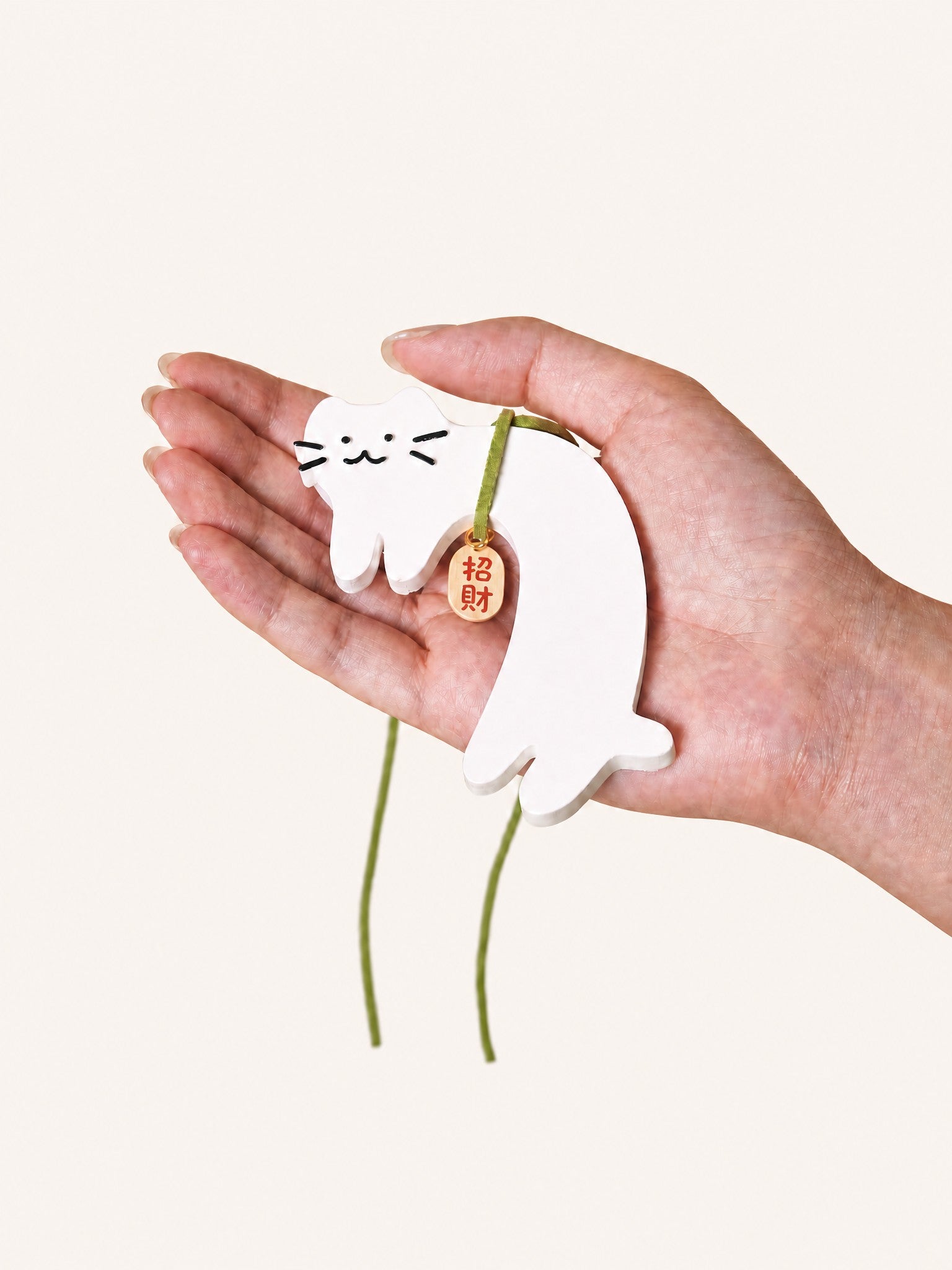 Cute white cat gypsum air freshener held in hand
