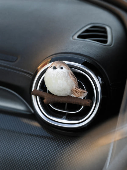 Beige chubby bird car vent diffuser on car interior