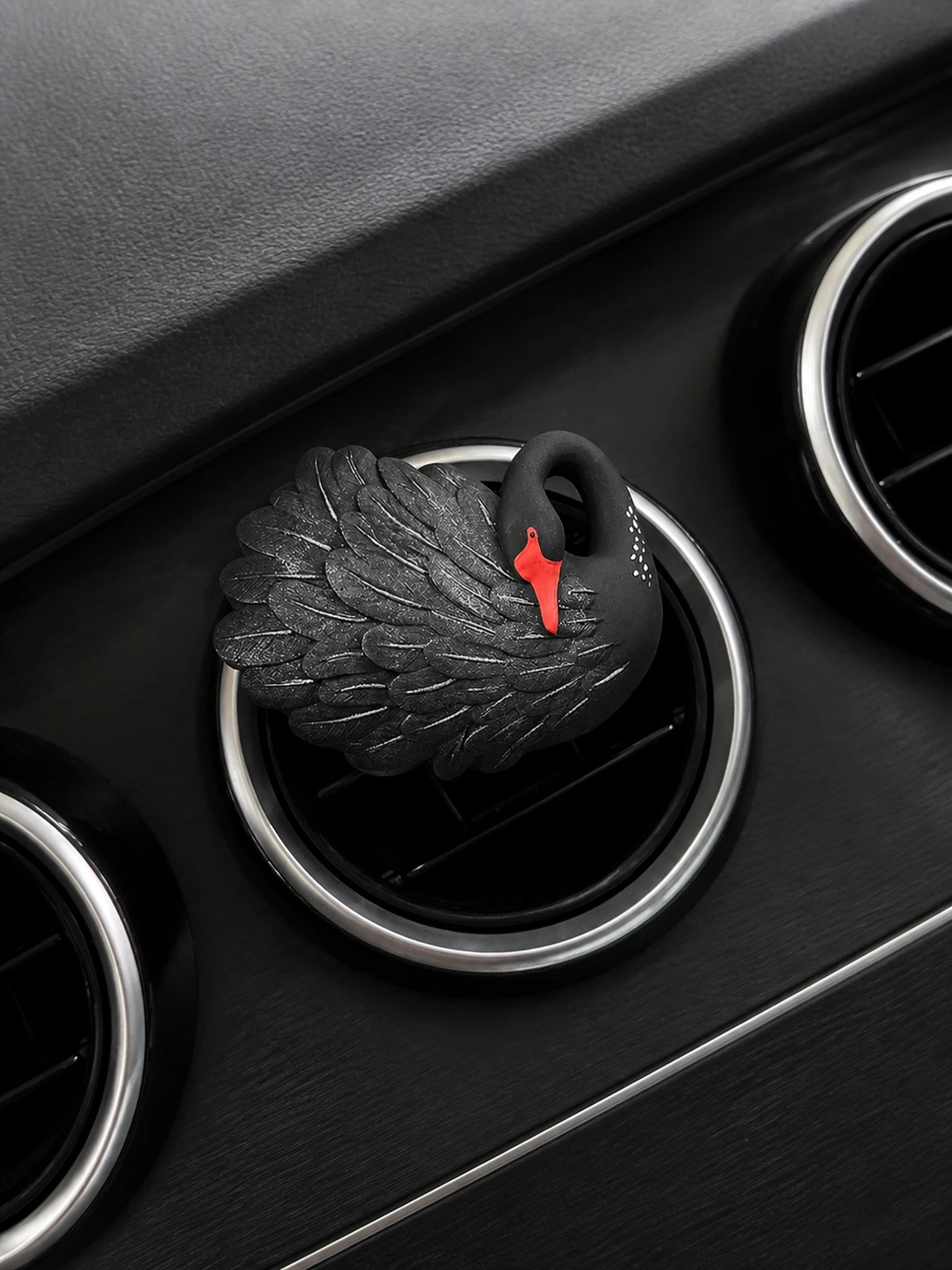 Black Swan sitting squarely on a compatible circular car vent