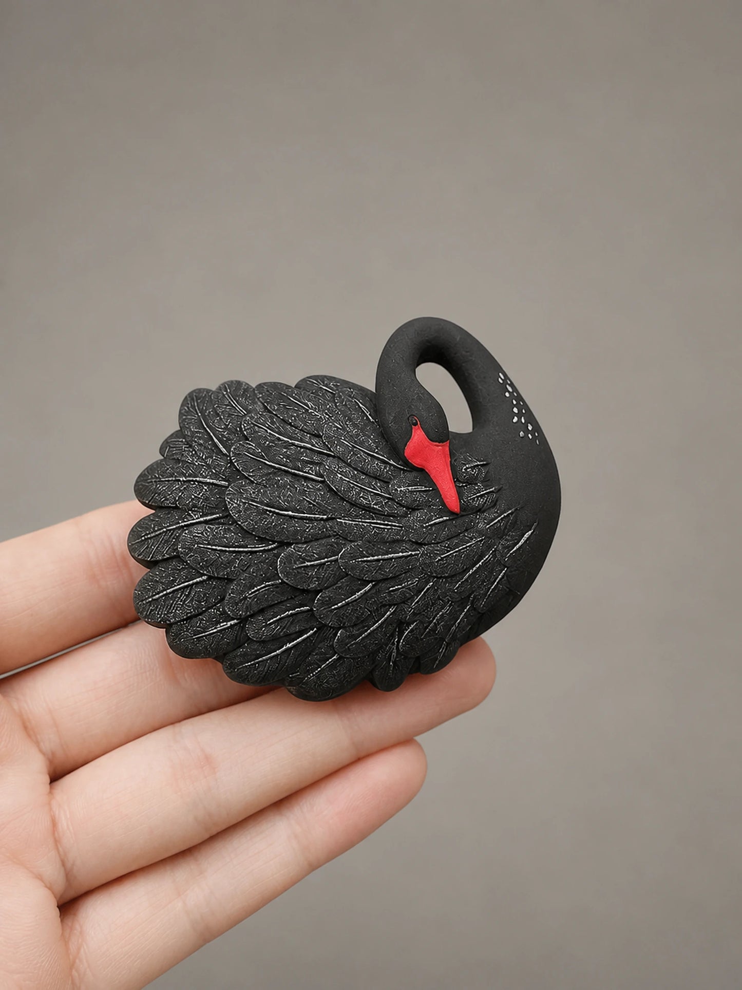 Black Swan car vent accent shown at an honest hand-held scale