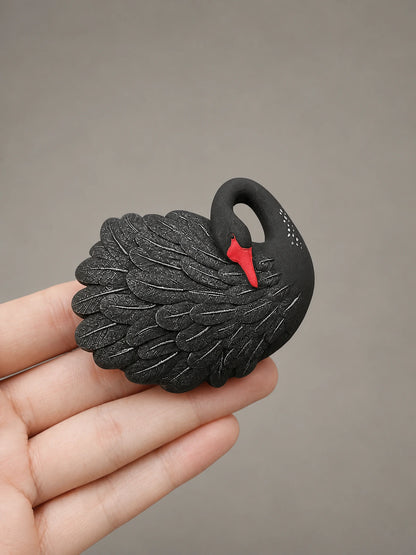 Black Swan car vent accent shown at an honest hand-held scale
