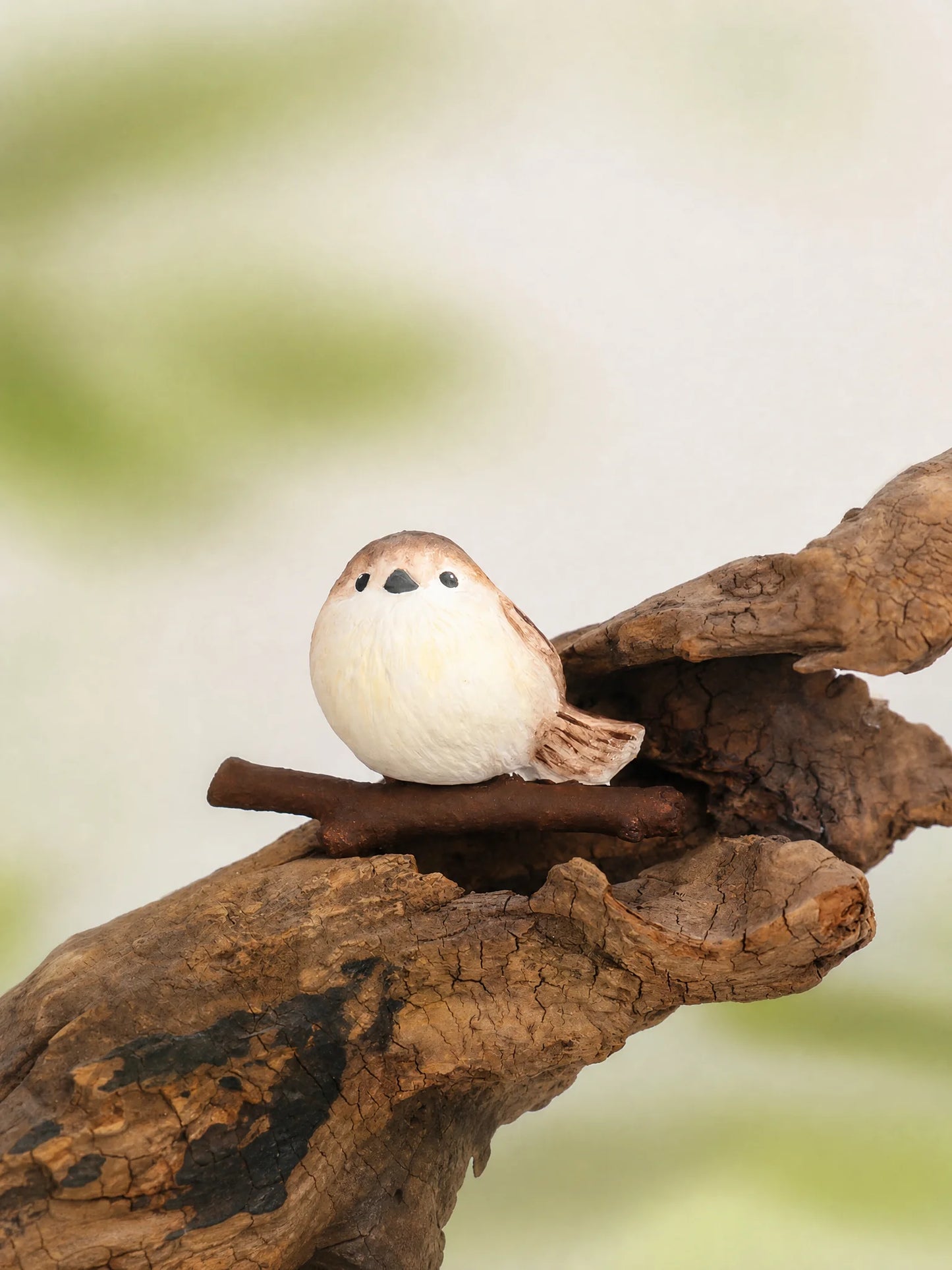 Chubby bird diffuser sitting on tree branch natural scene