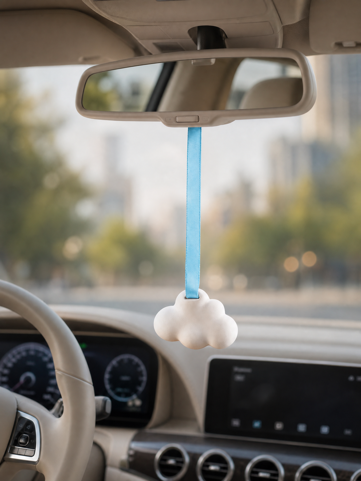 White cloud diffuser hanging inside car with beige interior