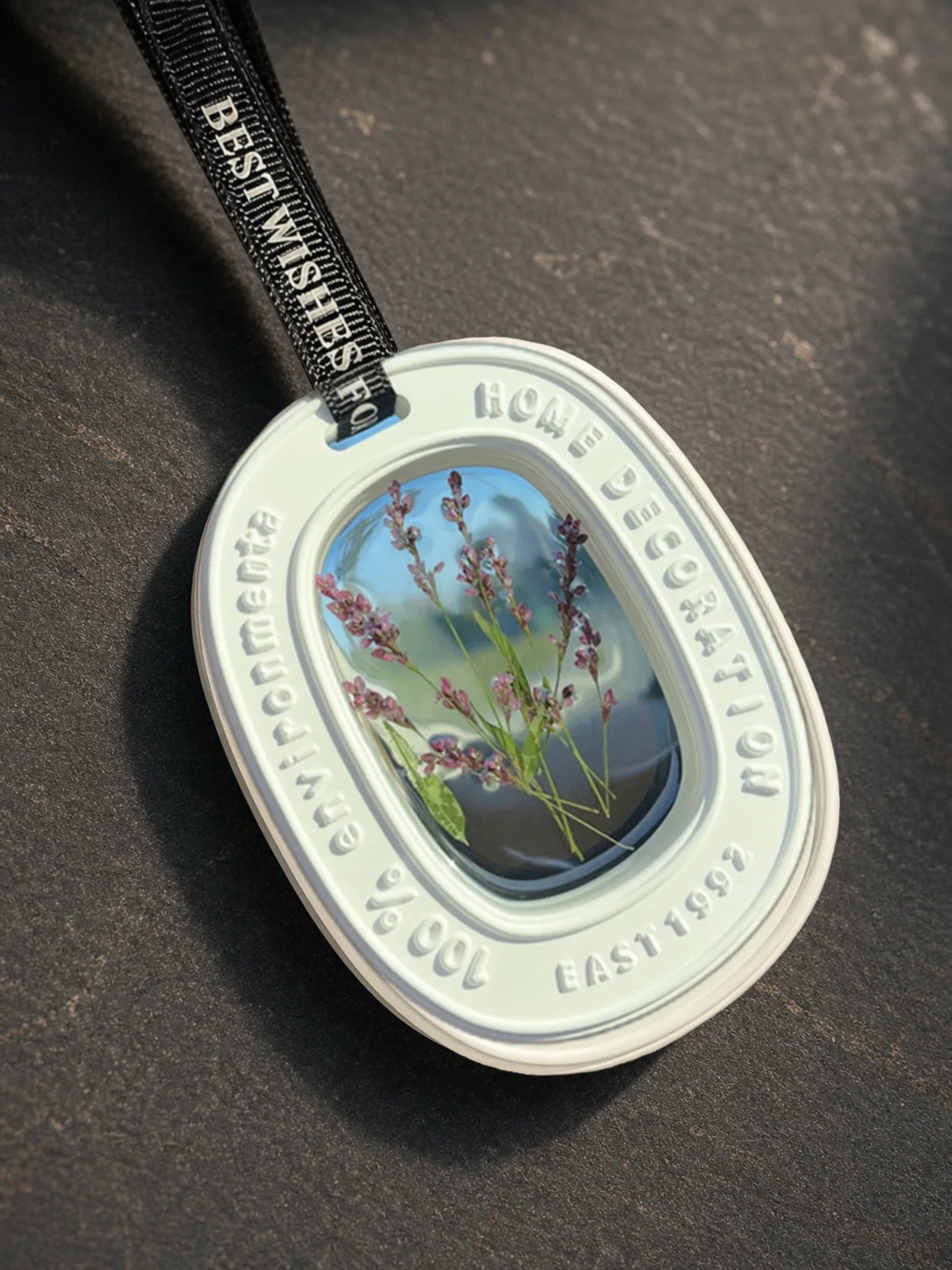Close detail of real dried purple stems inside the transparent oval window