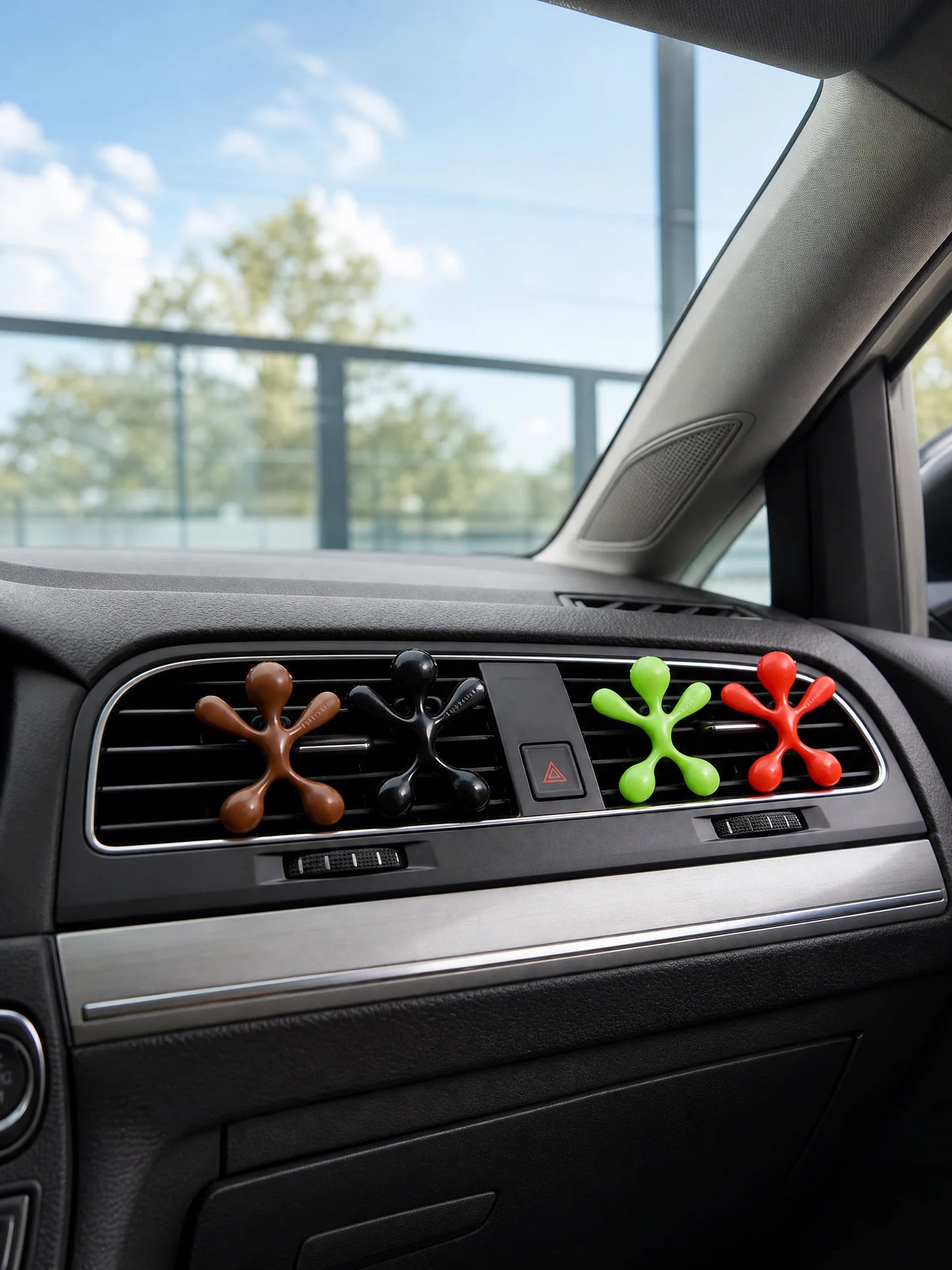 Four colorful octopus air fresheners clipped on car air vent