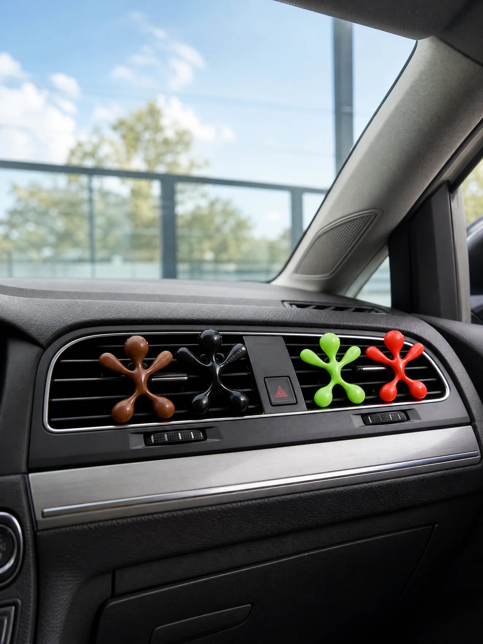 Four colorful octopus air fresheners clipped on car air vent