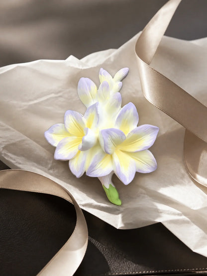 Lavender Cream Freesia ornament presented with neutral tissue for gifting inspiration