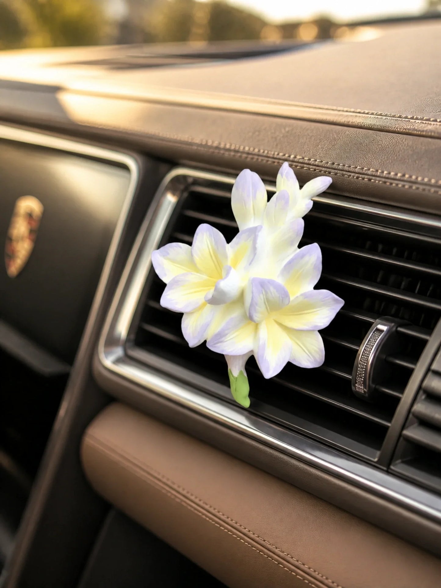 Lavender Cream Freesia ornament mounted on a Porsche horizontal vent