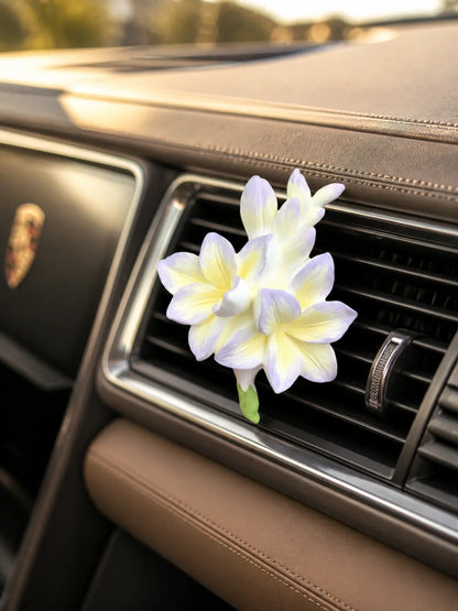 Lavender Cream Freesia ornament mounted on a Porsche horizontal vent