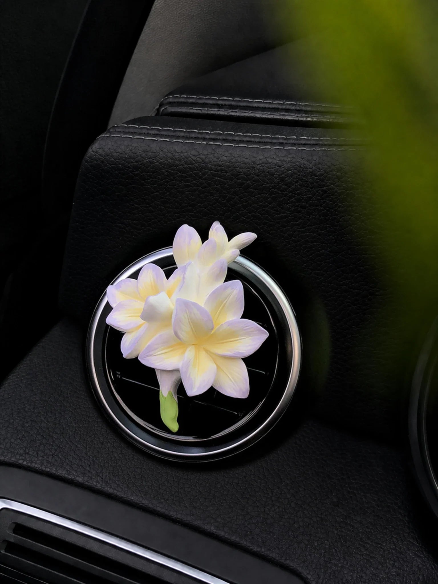 Lavender Cream Freesia ornament mounted naturally on a round car vent