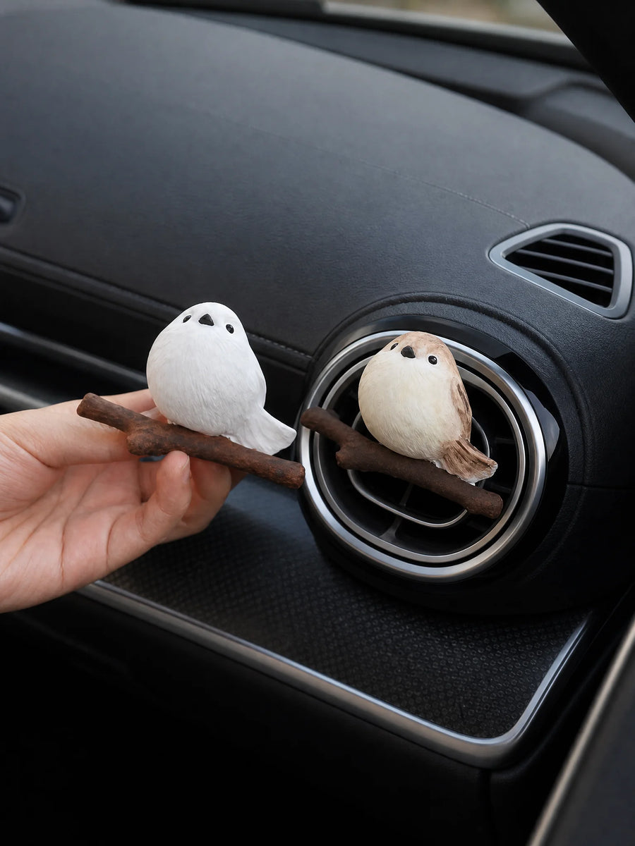 Hand installing chubby bird diffuser onto car air vent