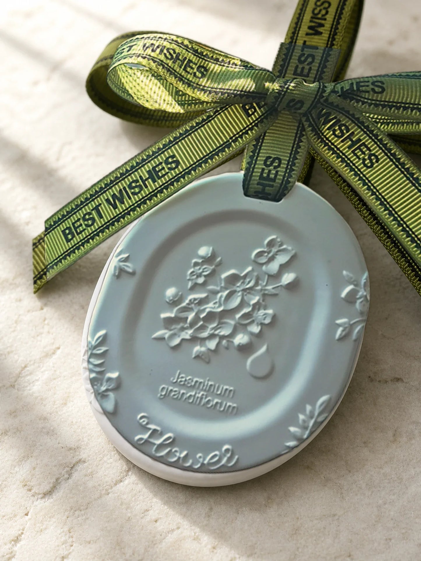 Close view of the jasmine botanical relief, butterfly details and physical lettering