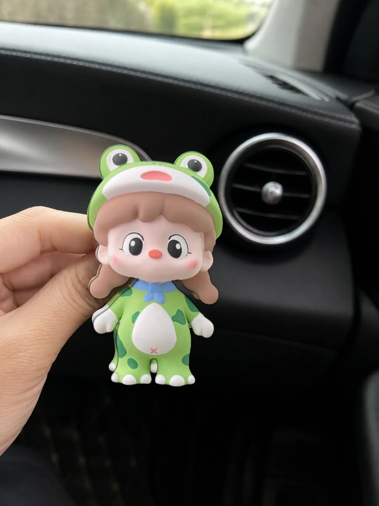 Green Frog Girl ornament shown in hand for an honest sense of scale