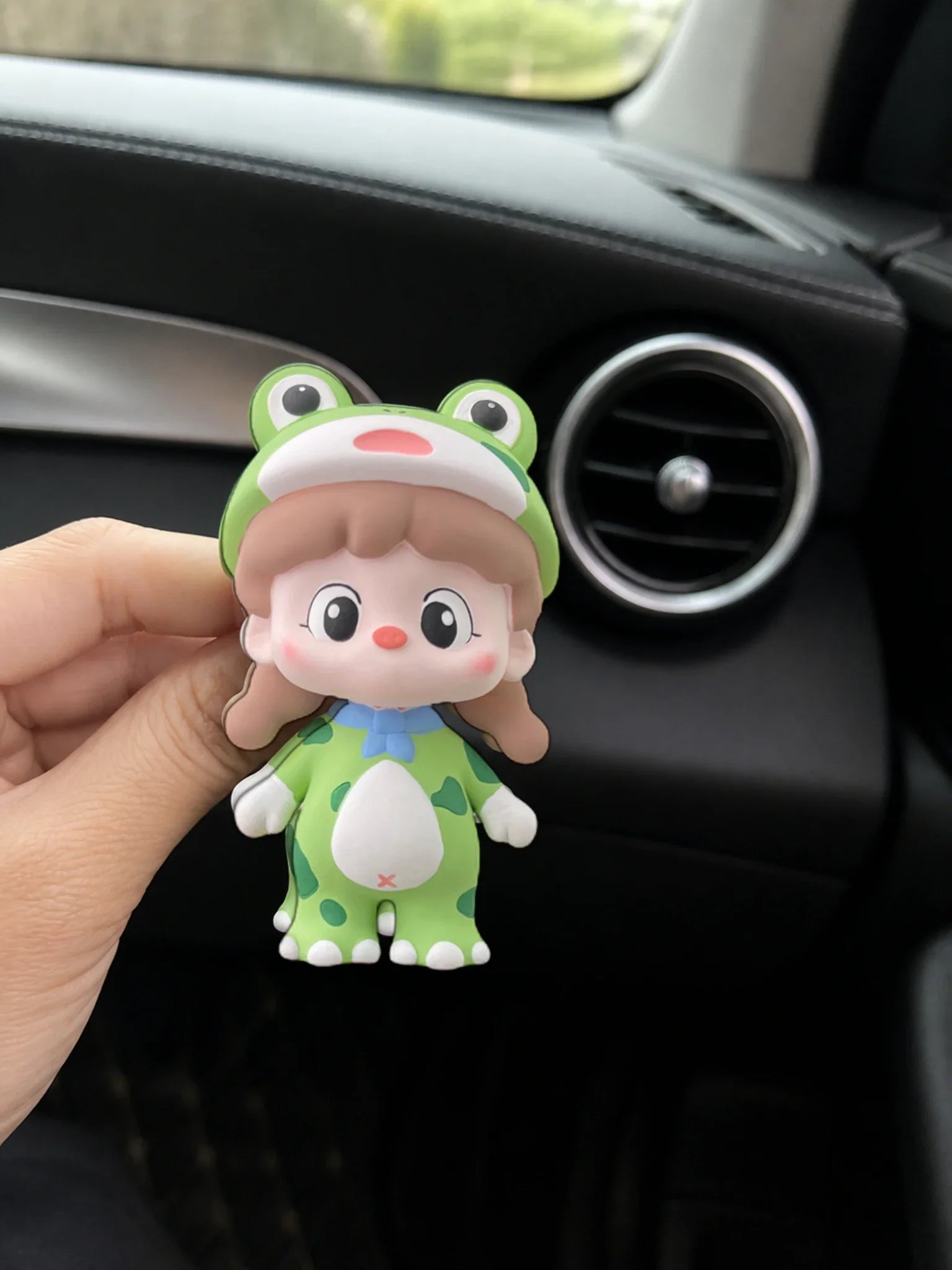 Green Frog Girl ornament shown in hand for an honest sense of scale