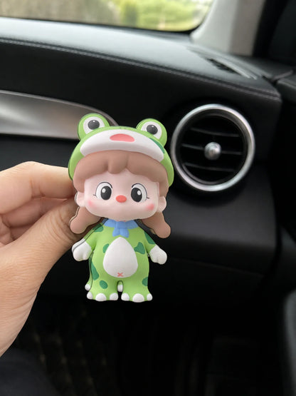 Green Frog Girl ornament shown in hand for an honest sense of scale