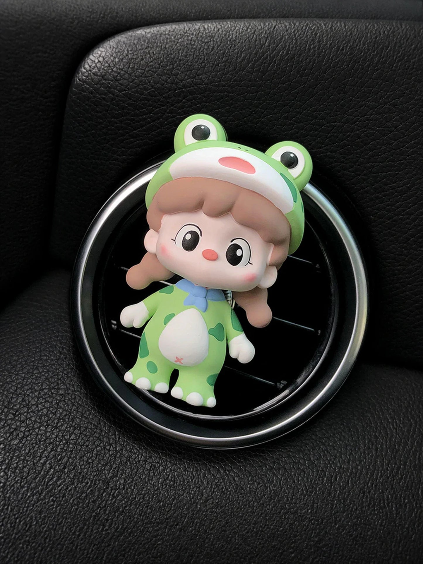 Green Frog Girl ornament mounted on a round car vent