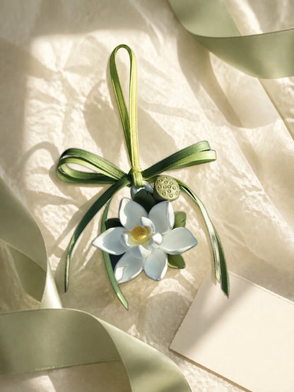 Lotus Serenity hanging car charm presented with neutral tissue and ribbon for gifting inspiration
