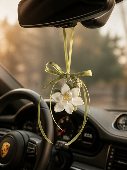 Lotus Serenity hanging car charm suspended naturally beneath a Porsche rearview mirror