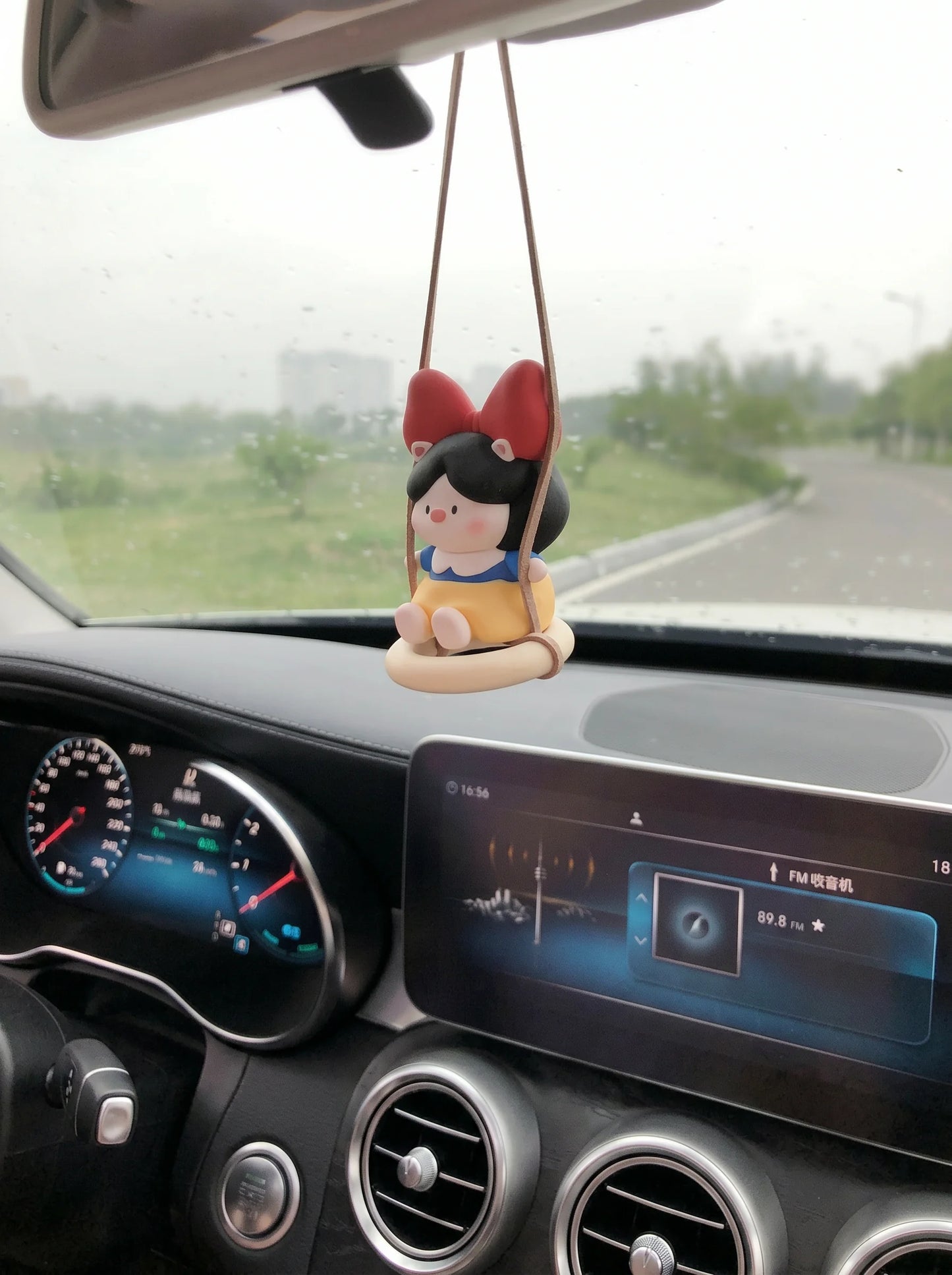 Pig Princess diffuser swinging on car rearview mirror