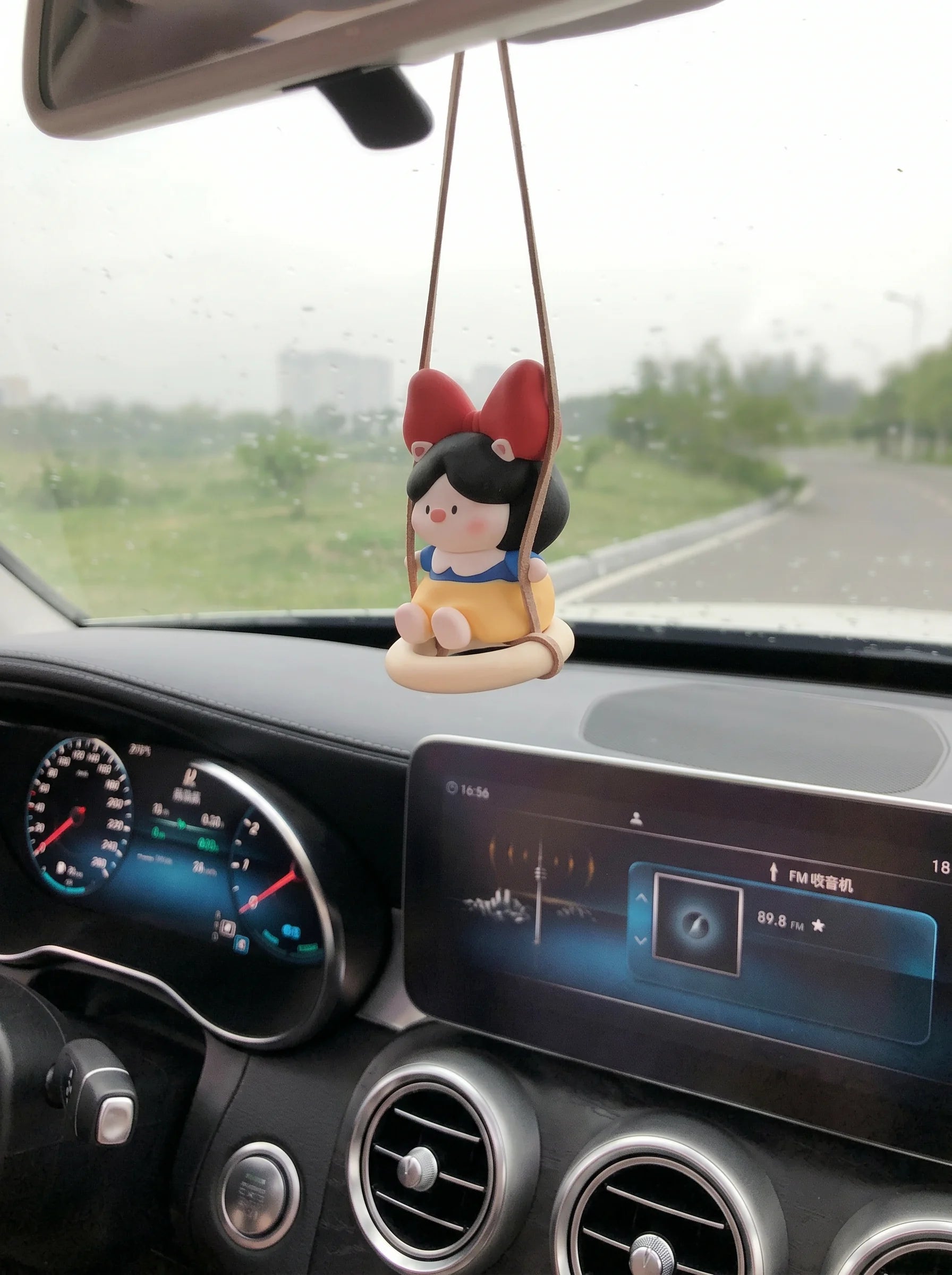 Pig Princess diffuser swinging on car rearview mirror