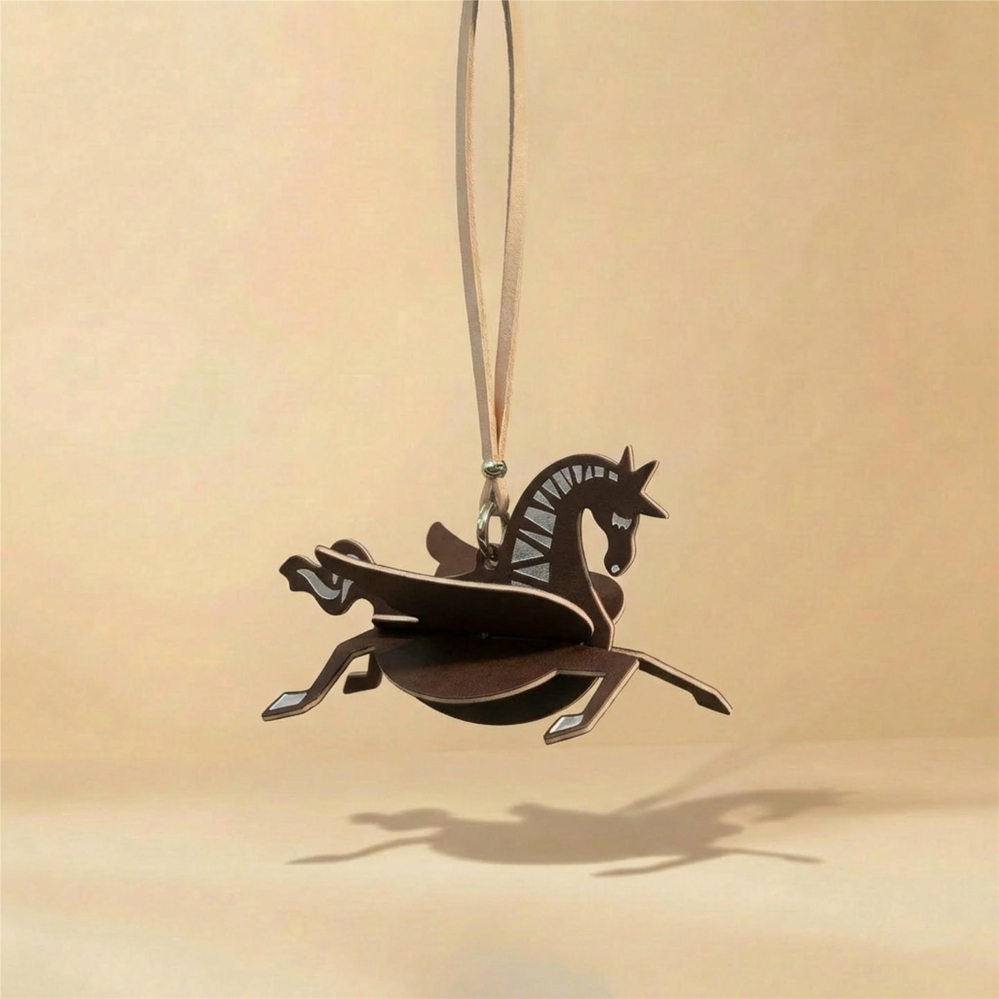Horse decorative fragrance charm hanging in a car or small space