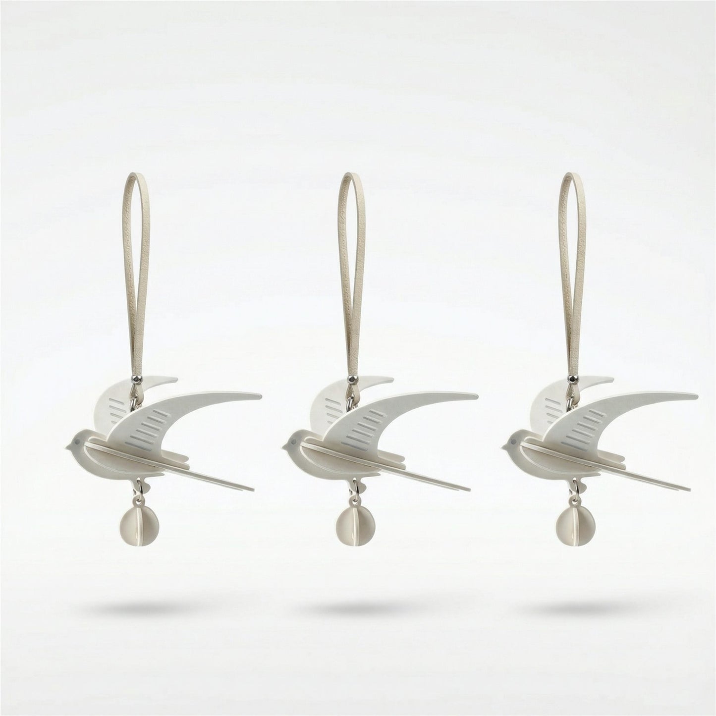 Hand-assembled swallow paper fragrance charm in soft neutral tones