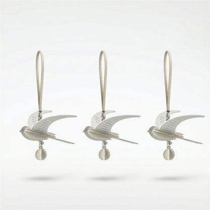 Hand-assembled swallow paper fragrance charm in soft neutral tones