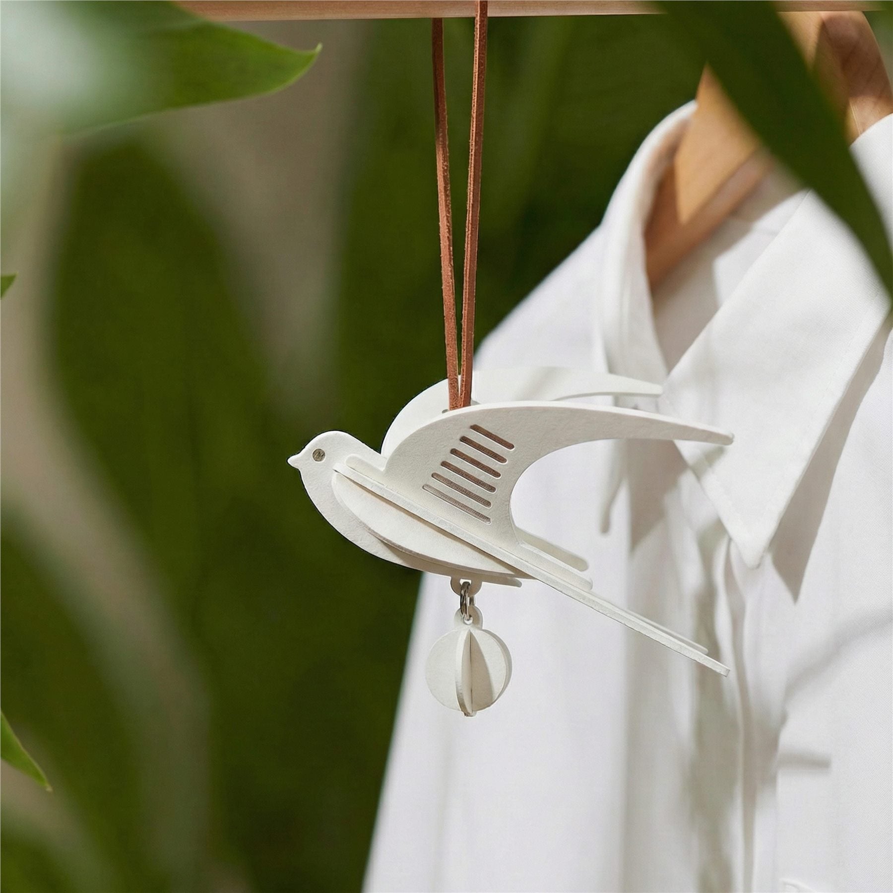 Hand-assembled swallow paper fragrance charm in soft neutral tones