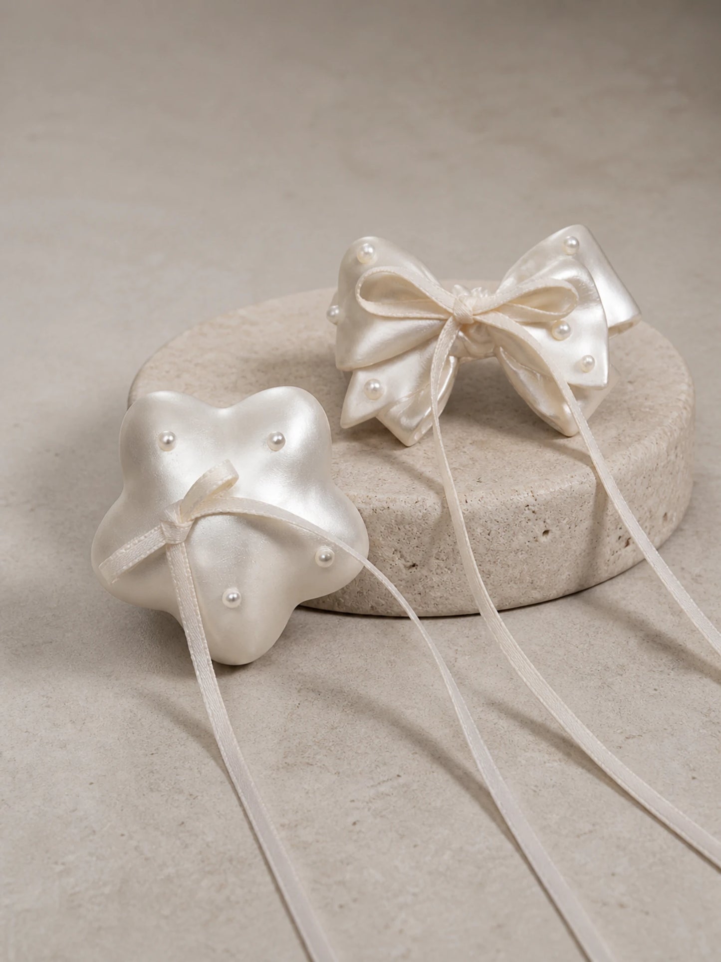 Pearl Wishes star and bow car vent ornaments on a clean neutral background