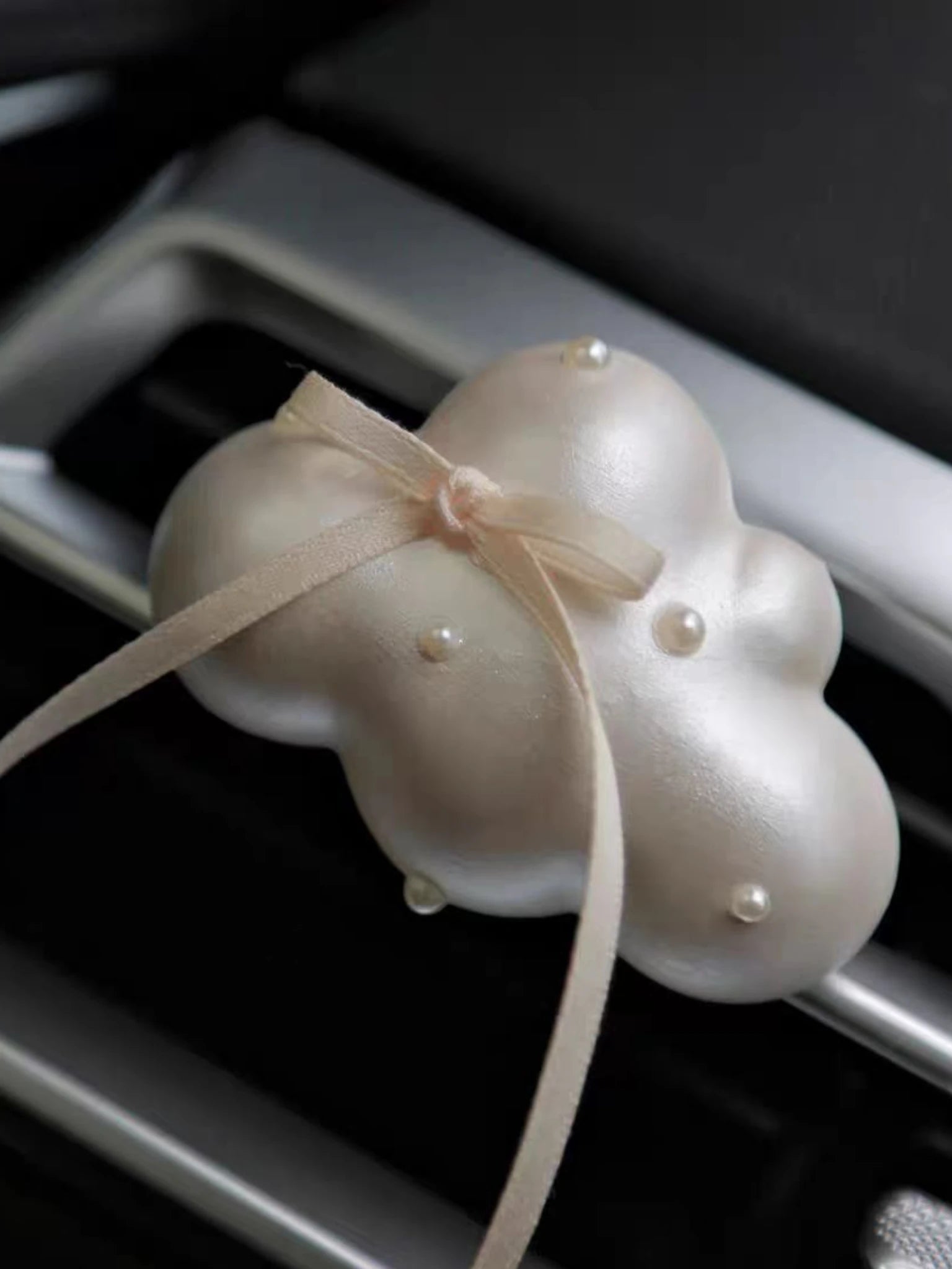 Close detail of the satin ribbon and pearl accents
