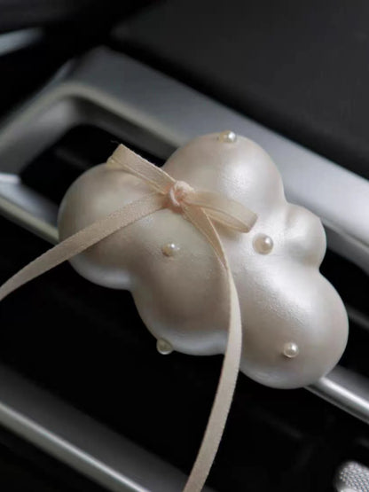 Close detail of the satin ribbon and pearl accents