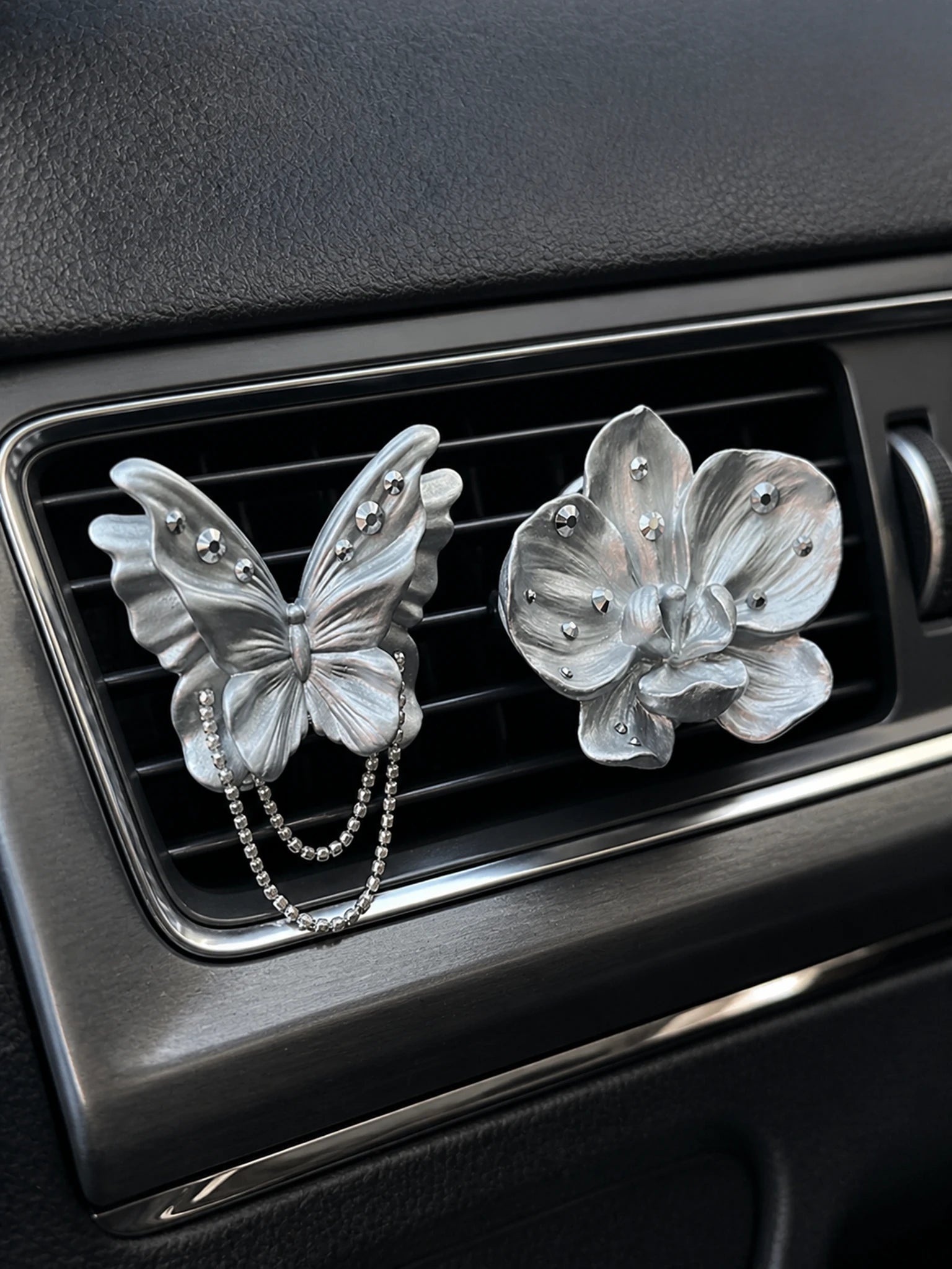 Pearl silver butterfly and orchid ornaments installed as separate car vent accents