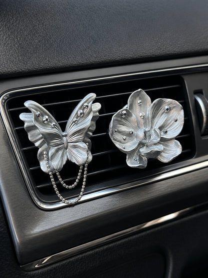 Pearl silver butterfly and orchid ornaments installed as separate car vent accents
