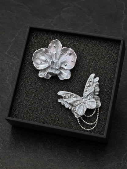 Butterfly and orchid gift set arranged in its black presentation box with a flush foam insert