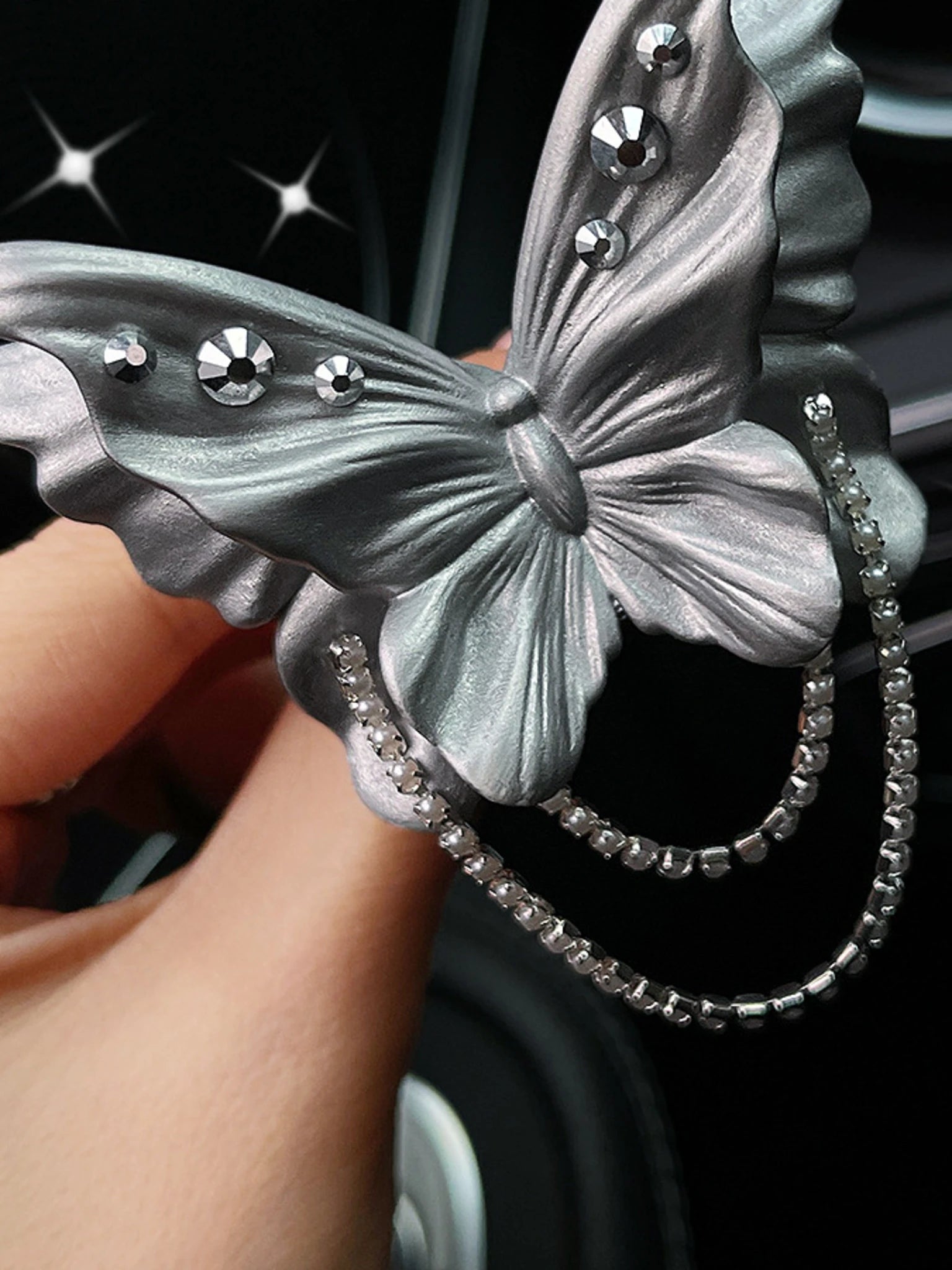 Close detail of the butterfly chains and crystal accents